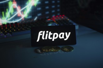 Flitpay logo in a dark setting with coins and a glowing financial chart
