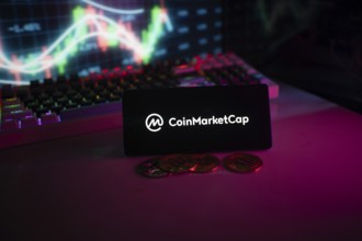 CoinMarketCap logo in a dark atmosphere with a colorful chart and coins