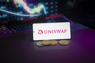 Uniswap logo displayed on a device surrounded by digital currencies and stock market charts