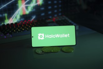 HaloWallet logo on smartphone with coins, green neon lights, and trading charts in background