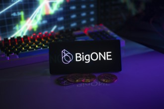 BigONE logo on smartphone with coins, neon lights, and trading charts in background