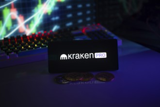 Kraken Pro logo on smartphone with coins, dark neon lights, and trading charts in background