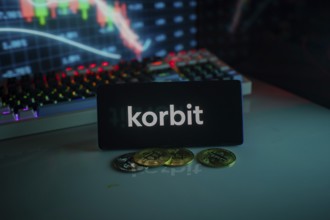 Korbit logo with cryptocurrency coins and market graph in neon-lit setting