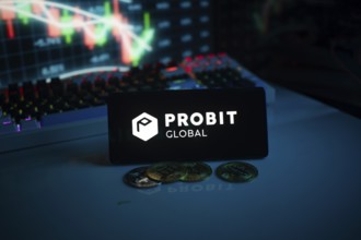 Probit Global logo with coins on a desk, against trading graphs backdrop