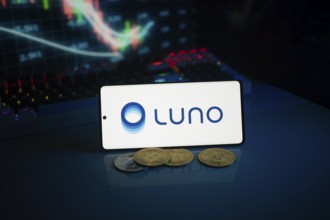 Luno logo alongside coins and a market trend graph in vibrant lighting
