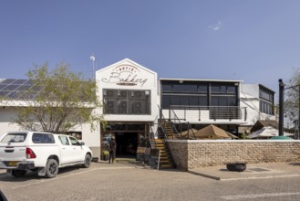 Street view of a modern building with a restaurant or café entrance in Outjo, Namibia 12 Augusto