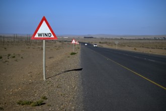 Caution wind sign on a road near Oranjemund, diamond restricted area, Karas region, Namibia