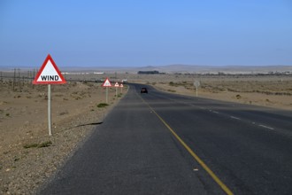Caution wind sign on a road near Oranjemund, diamond restricted area, Karas region, Namibia