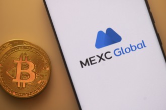 Bitcoin coin with a smartphone displaying the MEXC Global logo on a light background
