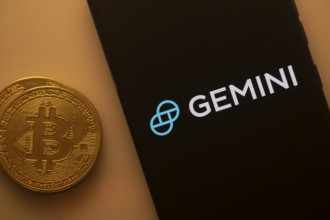Black Gemini screen and Bitcoin coin, symbolizing cryptocurrency exchange