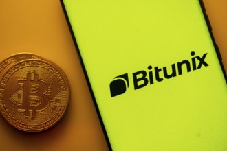 Yellow Bitunix screen with Bitcoin coin, symbolizing cryptocurrency platform