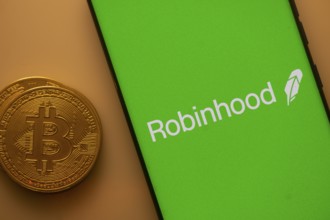 Green Robinhood screen with Bitcoin coin, representing cryptocurrency trading