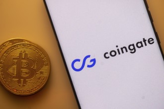 Bitcoin and Coingate logo on a smartphone against an orange background