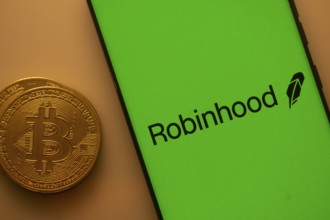 Robinhood logo on a smartphone screen with a Bitcoin coin