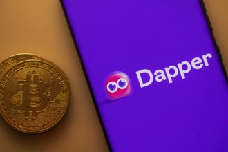 Dapper logo displayed on a smartphone next to a Bitcoin coin