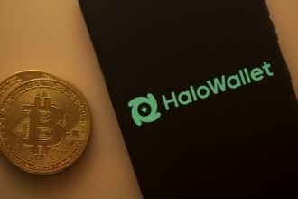 HaloWallet logo on a smartphone screen next to a Bitcoin coin