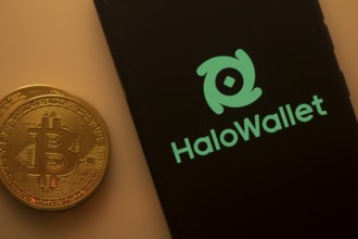 Bitcoin coin alongside phone showcasing HaloWallet logo on black background