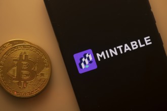 Bitcoin coin beside Mintable logo on a black background, representing cryptocurrency trade