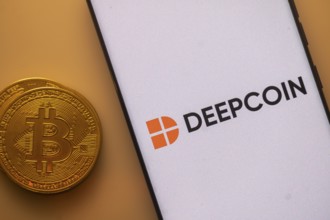 Deepcoin logo shows up on a smartphone screen near a Bitcoin coin on an orange background