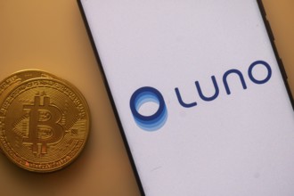 Bitcoin coin next to Luno logo on a white backdrop, indicating cryptocurrency exchange