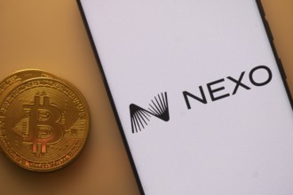 Nexo logo on smartphone screen beside Bitcoin, highlighting financial technology and cryptocurrency