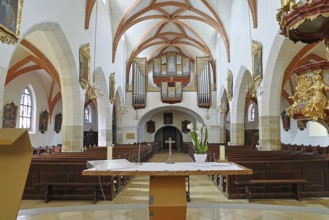 View of the altar and organ from the centre of the church, decorative vaults and artistic design,