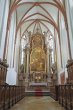 Majestic church altar with detailed woodwork and high ceiling structures, parish church of St
