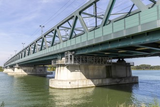 Modern metal bridge over a river with solid architecture and wet structures, old Danube bridge