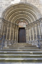 Romanesque stone door, carner with detailed decorations, symmetrically constructed, with stairs,