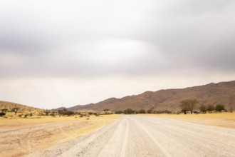 Dirt Road in Solitaire, Namibia, located on the edge of the Namib Desert, surrounded by dunes and