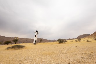 A mock Soviet rocket stands nose-first in the Solitaire, Namibian desert, surrounded by golden