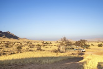The vast Namib Desert from Spreetshoogte Pass, with hazy plains, rugged mountains, and a lone house