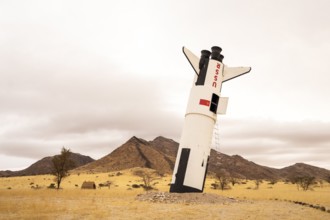 A mock Soviet rocket stands nose-first in the Solitaire, Namibian desert, surrounded by golden