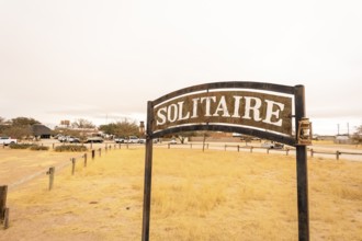 The remote desert settlement of Solitaire in Namibia features a sign displaying the town's name,
