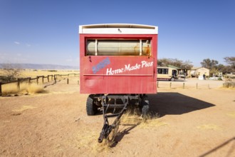 Solitaire's car graveyard in Namibia - 27 August, 2025: features rusted vintage cars near small