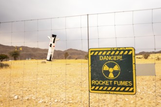 A mock Soviet rocket stands nose-first in the Solitaire, Namibian desert, surrounded by golden