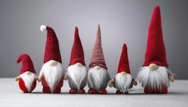Group of christmas gnomes with red hats and white beards standing together on gray background, AI