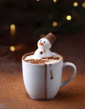 Delicious hot chocolate with funny marshmallow snowman melting on cocoa powder background with
