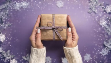 Woman holding christmas present with purple snowy background, AI generated
