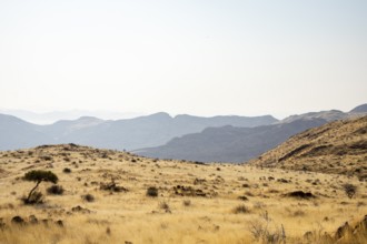 A picnic spot overlooks the vast Namib Desert from Spreetshoogte Pass, with hazy plains, rugged