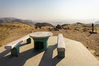 A picnic spot overlooks the vast Namib Desert from Spreetshoogte Pass, with hazy plains, rugged