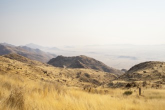 A picnic spot overlooks the vast Namib Desert from Spreetshoogte Pass, with hazy plains, rugged