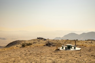 A picnic spot overlooks the vast Namib Desert from Spreetshoogte Pass, with hazy plains, rugged