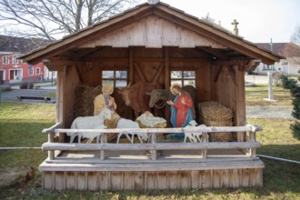 Depiction of the Nativity scene in a traditional nativity scene scene with figures and animals,