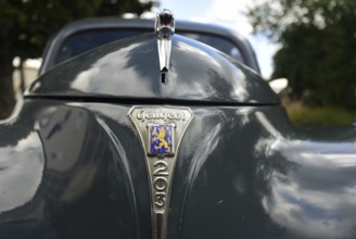 Front view of a vintage Peugeot 203, seen at a company anniversary of Energie-Mann in Westerwald