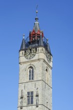 Close-up of 14th century Gothic belfry tower with carillon and clock in the historic city centre of