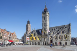 City hall with belfry, restaurants and pavement cafes on Market Square in historic town centre of
