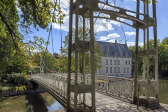 Suspension bridge in park of Kasteel Cortewalle, 15th century moated castle at Beveren in summer,