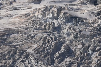 Impressive scene shows lines and textures on residual ice cream in mountains. Daylight emphasises