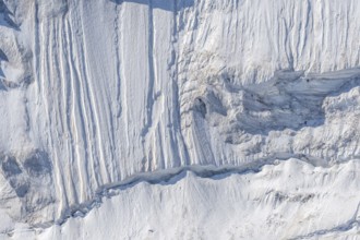 Impressive scene shows lines and textures on residual ice cream in mountains. Daylight emphasises